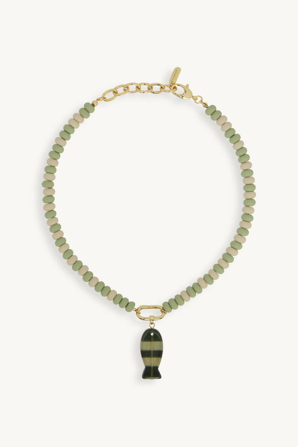Necklace with green beads and a fish-shaped pendant on a white background