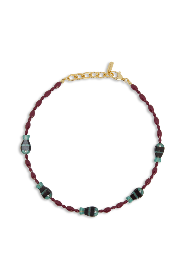 Necklace with braided red cord and green beads on a white background