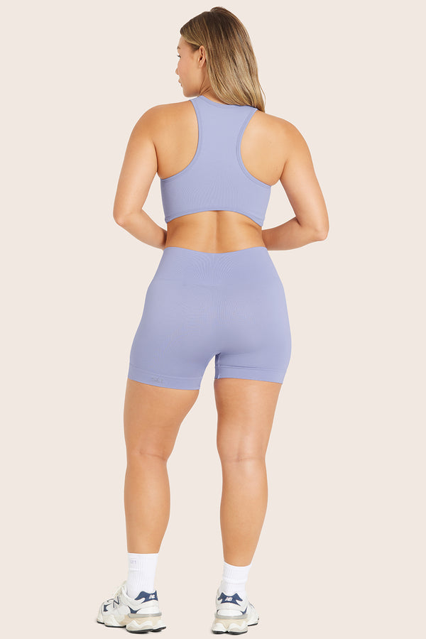 MODEL WEARS SCULPTFLEX® BIKE SHORTS IN LILY 