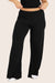 MODEL WEARS SLEEP JERSEY CLASSIC SLEEP PANTS IN ONYX 
