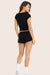 MODEL WEARS SLEEP JERSEY RELAXED SLEEP SHORTS IN ONYX 
