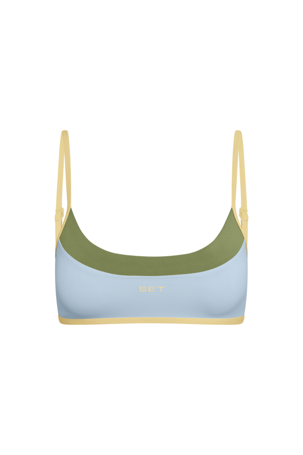 Bikini top with green and blue design on a white background
