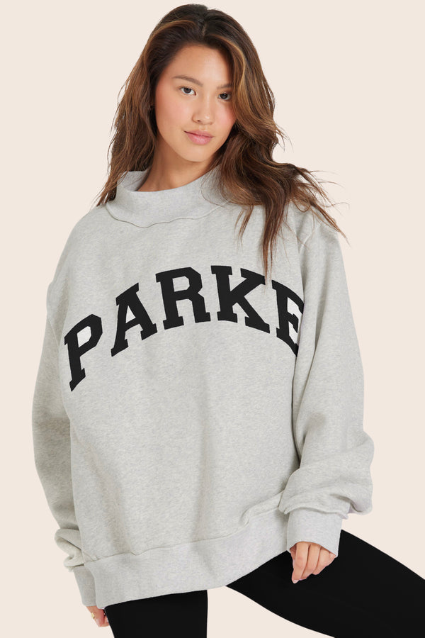 MODEL WEARS SET X PARKE REVERSIBLE VARSITY MOCKNECK IN PARKE HEATHER GREY 