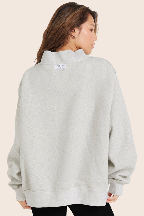 MODEL WEARS SET X PARKE REVERSIBLE VARSITY MOCKNECK IN PARKE HEATHER GREY 