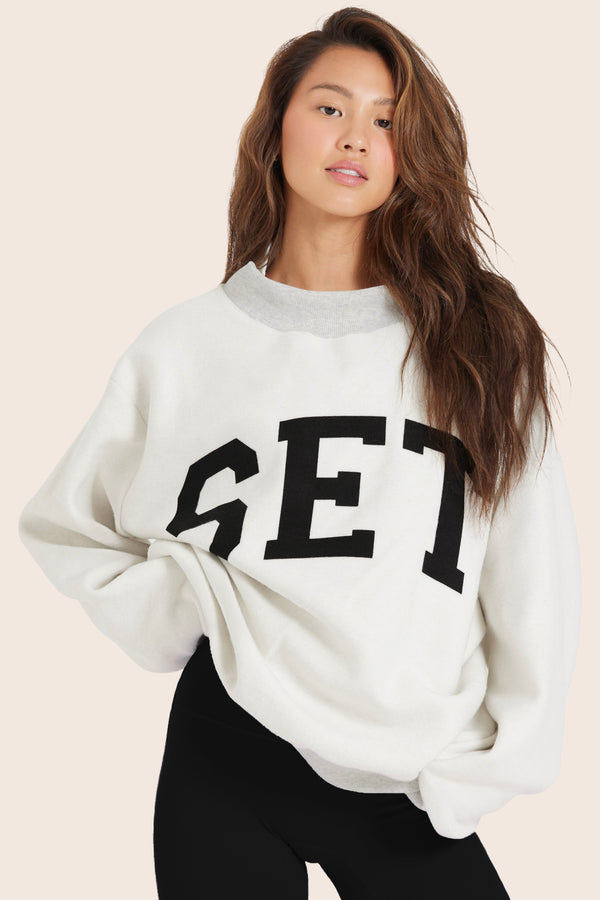 MODEL WEARS SET X PARKE REVERSIBLE VARSITY MOCKNECK IN PARKE HEATHER GREY 