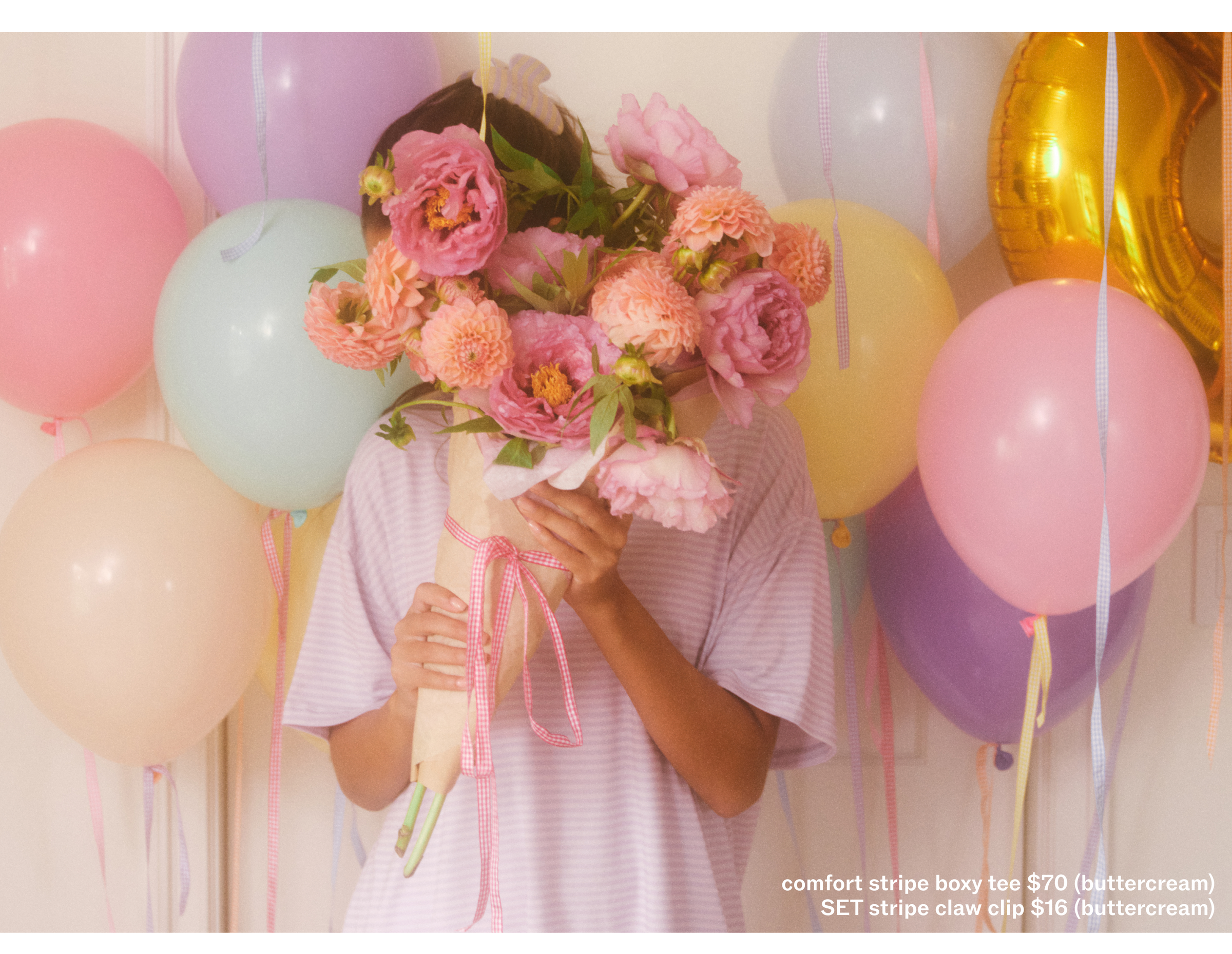 Person holding flowers with balloons in the background