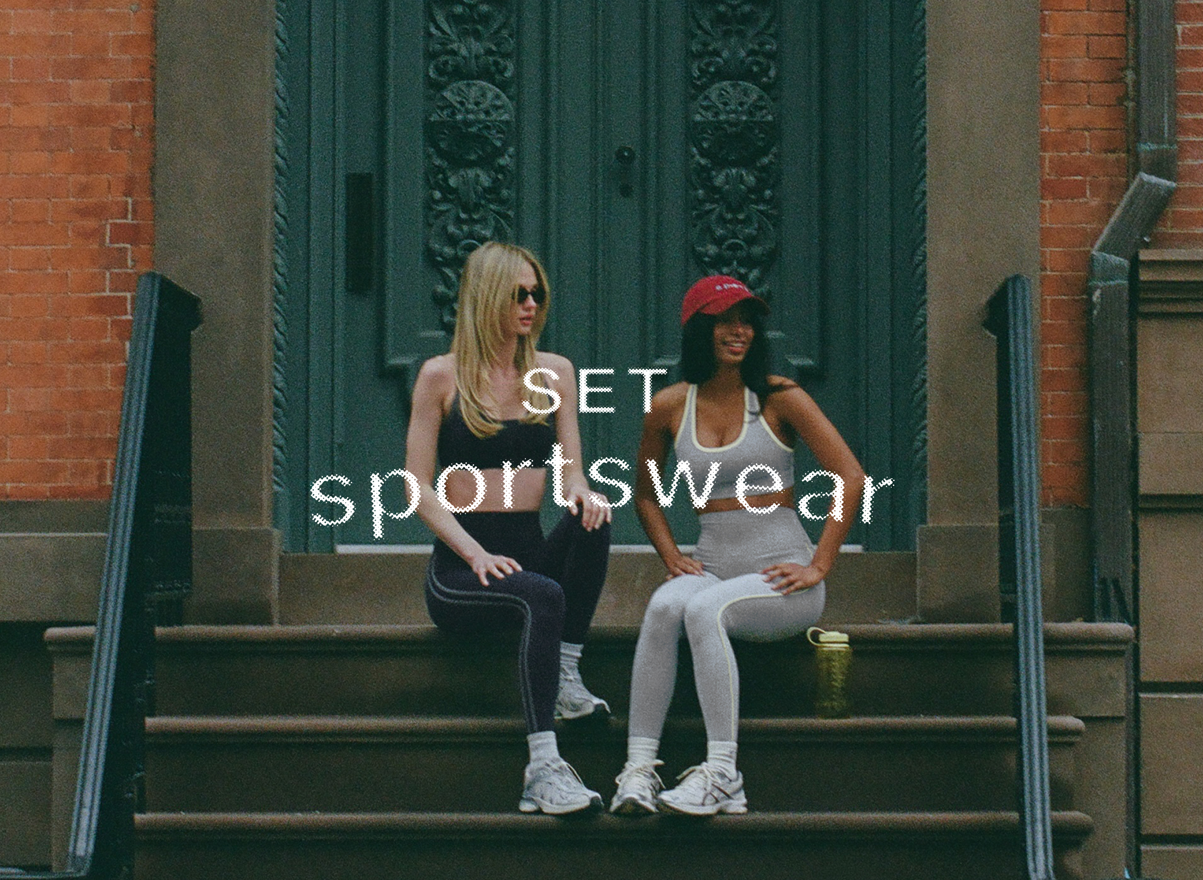 Two women sitting on steps wearing athletic wear with 'SET sportswear' branding.