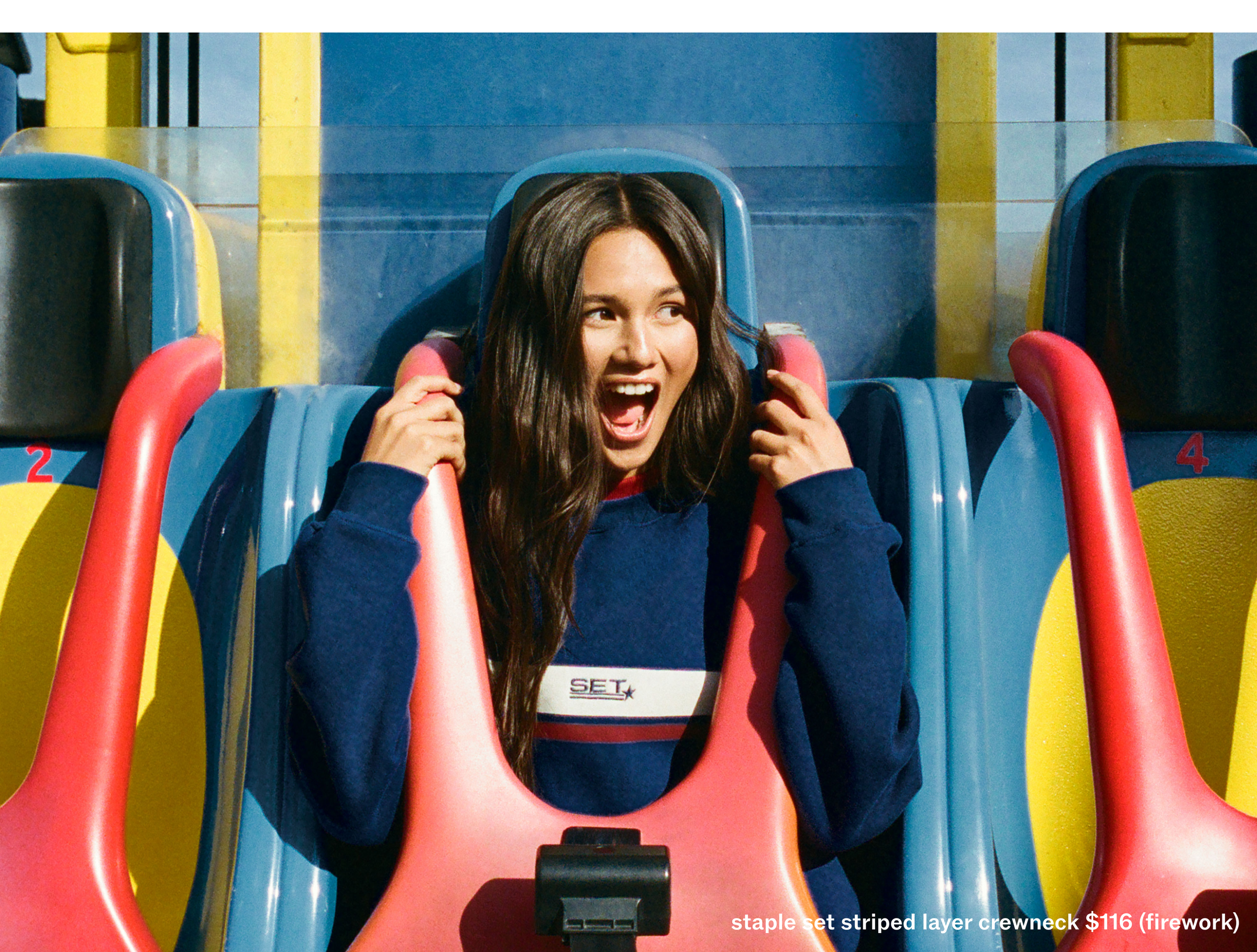 Person on a roller coaster with a blue and yellow striped background