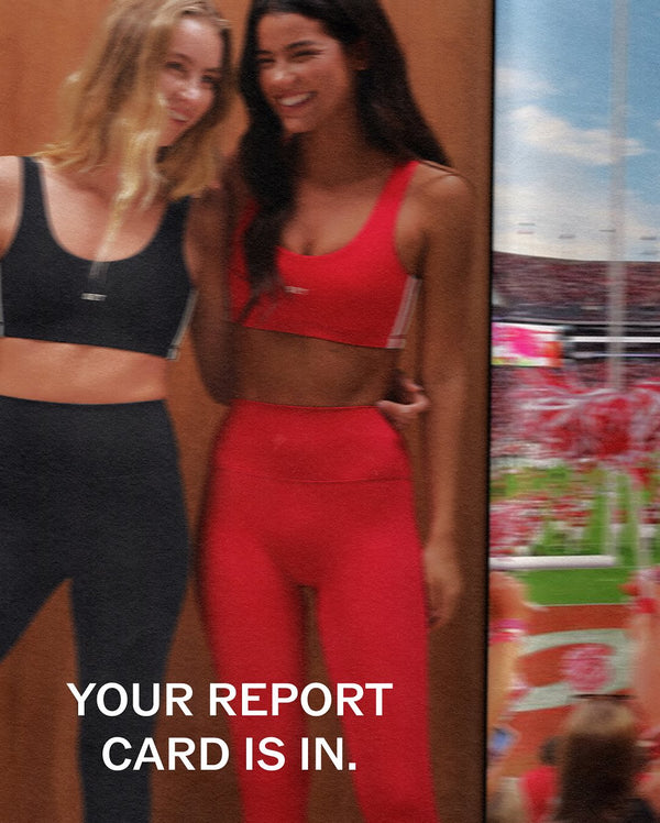 Two women in athletic wear with a sports field background and text 'YOUR REPORT CARD IS IN'.