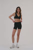 MODEL WEARS SPORTBODY® BIKE SHORTS IN ONYX