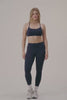 MODEL WEARS AIRLUXE™ BREATHE MID-RISE LEGGINGS IN SPADES