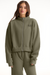 Person wearing a green tracksuit with 'SET' logo on a white background <model-info>Sophie wears a size L and is 5’9½”, 23” waist, 34CD bust.</model-info>